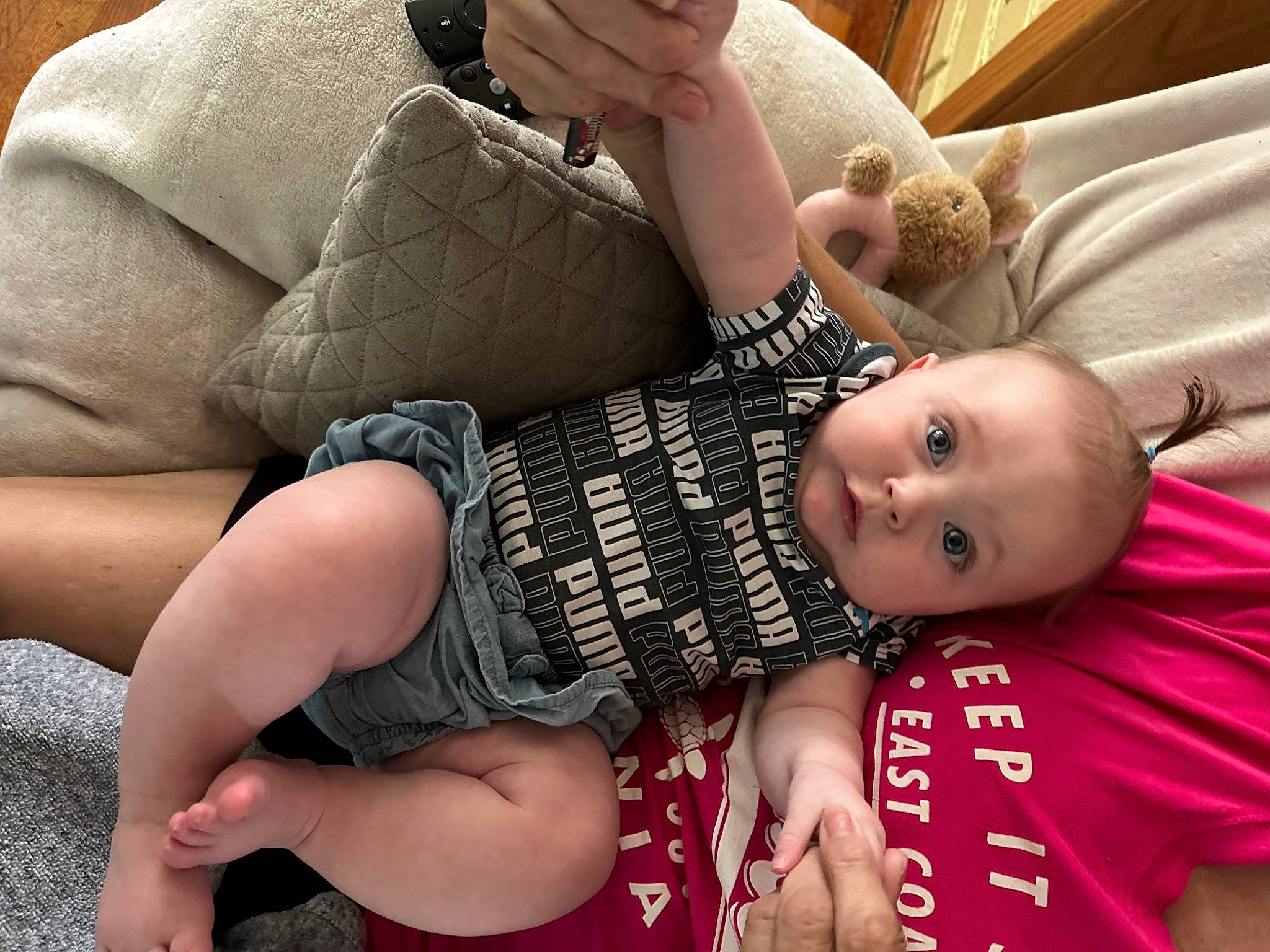 Harper is registered to the contest to win money with this photo: arm, baby, baby_toddler_clothing, comfort, eyewear, finger, hand, happy, human_leg, joint, knee, lap, leg, mouth, muscle, person, skin, sleeve, smile, thigh