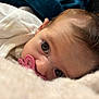 élise a rejoint le concours — aidez-le/la à gagner de superbes lots ! baby, pacifier, closeup, face, infant, blanket, soft, lying_down, curious, cute, human, skin, hair, indoors, sleepwear, newborn, resting, portrait, child, cozy