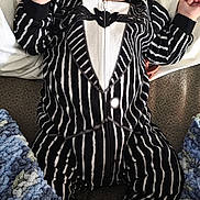 James joined the competition — help win amazing prizes! baby, infant, onesie, striped_clothing, black_and_white, pillow, blanket, knitted_blanket, carpet, indoor, portrait, child, cute, lying_down, soft_texture, hand, face, expression, yellow_sock, cozy