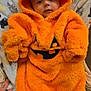 James joined the competition — help win amazing prizes! baby, infant, orange_clothing, hooded_outfit, blanket, whale_pattern, cute, indoors, portrait, child, cozy, soft_texture, pumpkin_face, seasonal, fall, holiday, smiling, person, warm, comfort
