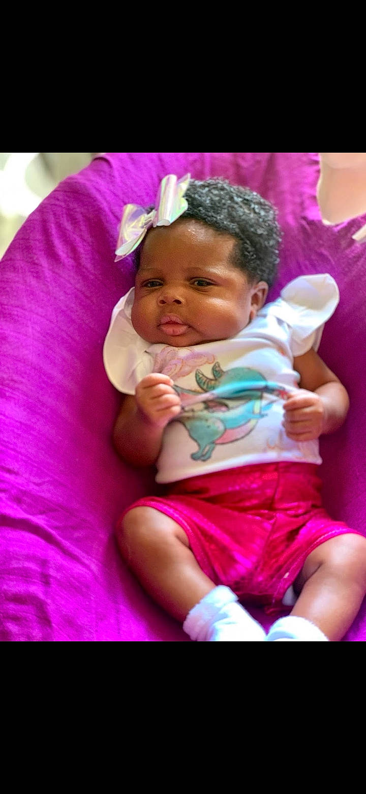 Xairia is registered to the contest to win money with this photo: abdomen, baby, baby_toddler_clothing, child, comfort, fun, grass, happy, leg, leisure, magenta, person, pink, play, portrait_photography, purple, sitting, skin, t_shirt, thigh