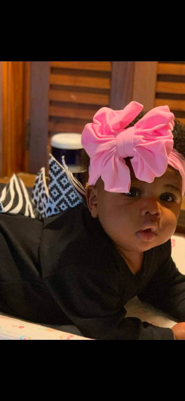 Xairia is registered to the contest to win money with this photo: baby, baby_toddler_clothing, child, chin, comfort, costume, costume_accessory, costume_hat, eyelash, fashion_accessory, hair_accessory, headband, headgear, headpiece, headwear, magenta, neck, pattern, person, petal