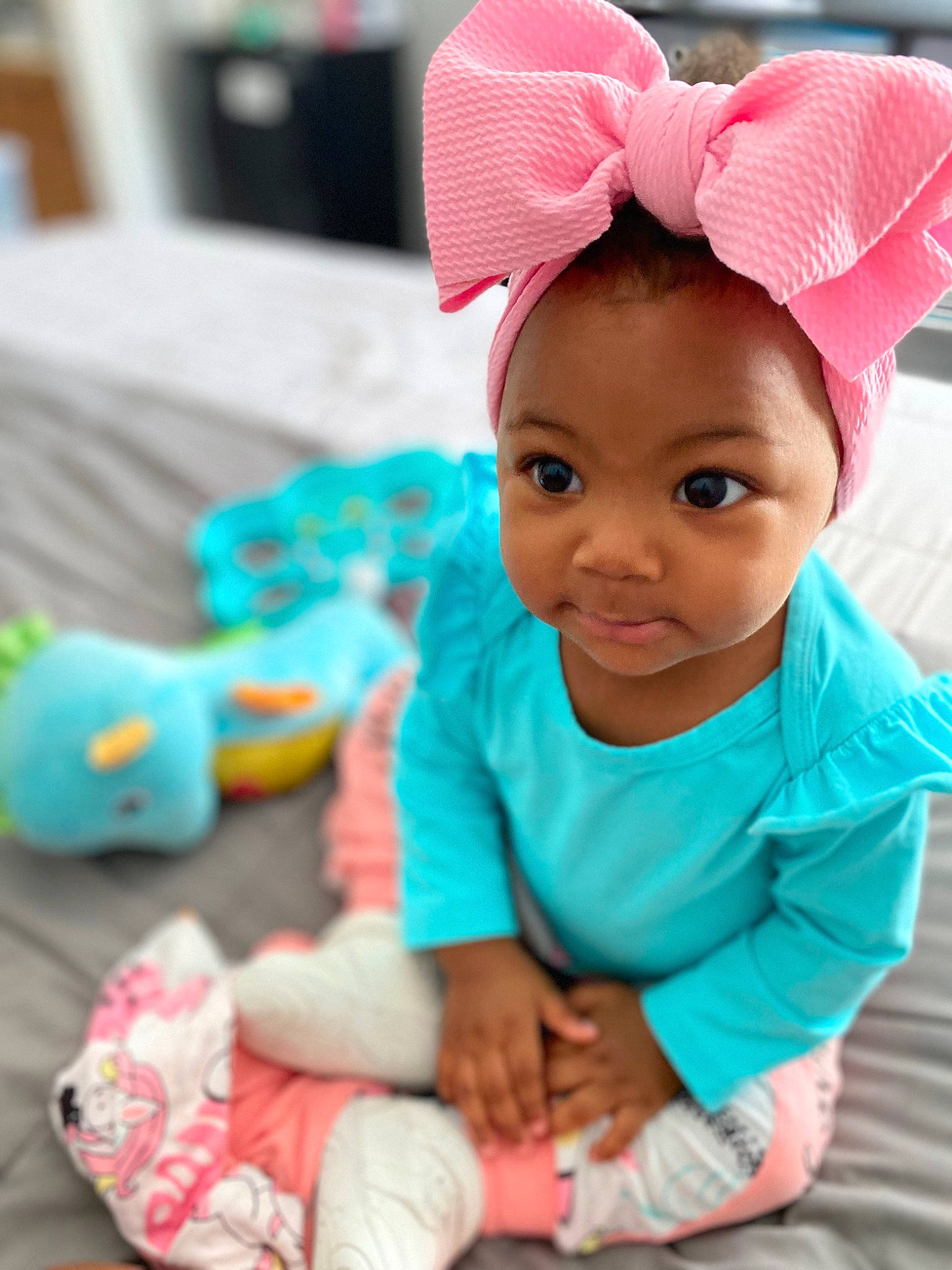 Nylah is registered to the contest to win money with this photo: baby, baby_toddler_clothing, cap, child, eyelash, facial_expression, fashion_accessory, fun, happy, headband, headgear, human_body, magenta, person, pink, product, skin, sleeve, smile, textile