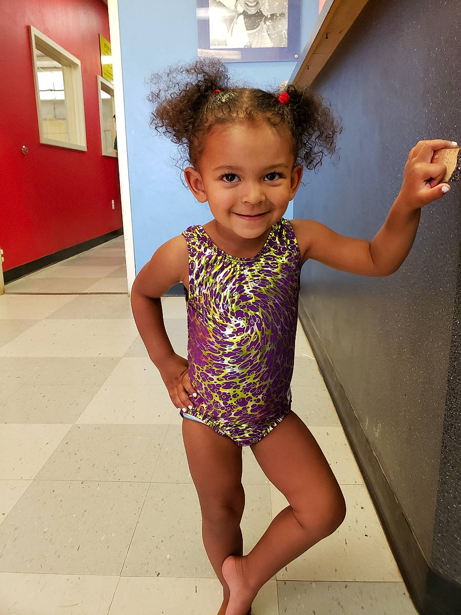 Aaniya is registered to the contest to win money with this photo: child, child_model, clothing, human_leg, joy, leg, leotard, maillot, one_piece_swimsuit, person, sportswear, swimwear, thigh, toddler
