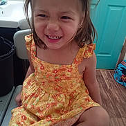 Marla Victoria joined the competition — help win amazing prizes! chair, child, cute, door, expression, floral_pattern, girl, hair, happy, indoor, person, pigtails, playful, seated, sink, smile, teeth, wooden_floor, yellow_dress, young
