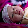Marla is registered to the contest to win money with this photo: baby, bed, blanket, bodypart, bonnet, cap, clothing, face, furniture, happy, hat, head, newborn, person, photography, portrait, purple, quilt, sleeping, smile