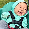 Marla is registered to the contest to win money with this photo: baby, babylaughing, clothing, coat, face, grass, gun, happy, hat, head, jacket, lifejacket, outdoors, person, photography, plant, portrait, smile, vest, weapon