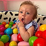 baby, ball_pit, blue, blue_eyes, child, clothing, colorful_balls, cute, green, indoor, person, pink, play, playpen, portrait, purple, red, surprised_expression, toddler, yellow