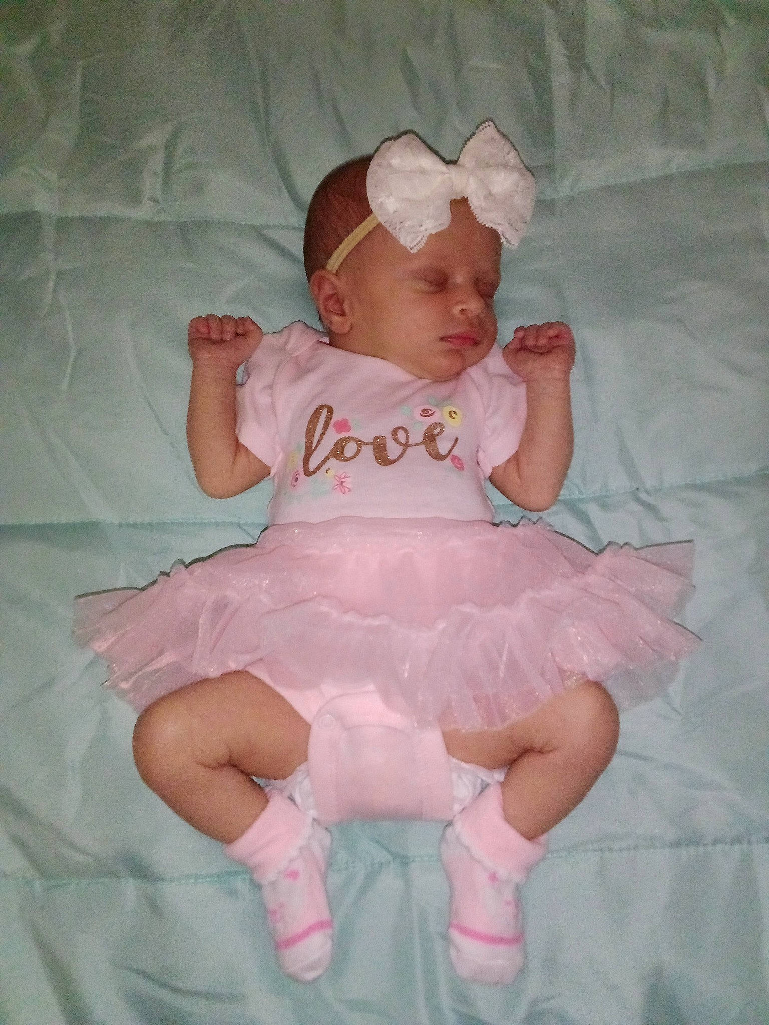 Evangeline joined the competition — help win amazing prizes! baby, baby_toddler_clothing, comfort, day_dress, dress, embellishment, face, fashion_accessory, hair_accessory, headgear, human_leg, pattern, peach, person, pink, ruffle, sitting, skin, sleeve, textile