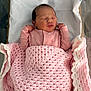 newborn, baby, sleeping, pink_blanket, pink_outfit, hospital_bassinet, white_sheet, infant, cozy, cute, peaceful, small_hands, face, closed_eyes, indoor, soft_texture, crochet_blanket, portrait, child, resting