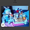 Kisa participe au concours pour gagner de l'argent avec cette photo : animal, blue_cushion, box, cat, collection, colorful, couch, cozy, cute, domestic_animal, feline, indoor, orange_cat, pet, pink_blanket, plush_toys, relaxed, seated, soft_toys, stuffed_animals