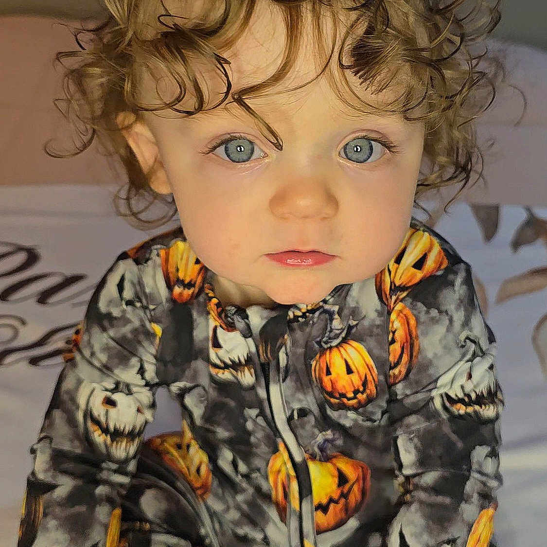 Paxton is registered to the contest to win money with this photo: baby, blonde, clothing, coat, crawling, dress, face, hair, happy, head, jacket, longsleeve, pajamas, person, photography, portrait, sleeve, smile, toy, wig