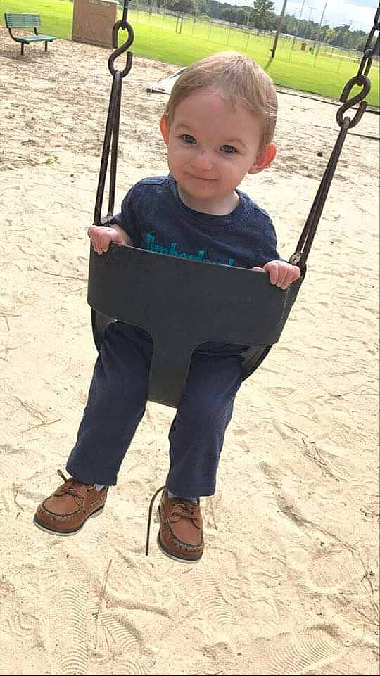 Brennon is registered to the contest to win money with this photo: child, fishing_rod, fun, joy, outdoor_play_equipment, person, play, playground, public_space, recreation, smile, swing, toddler, vacation