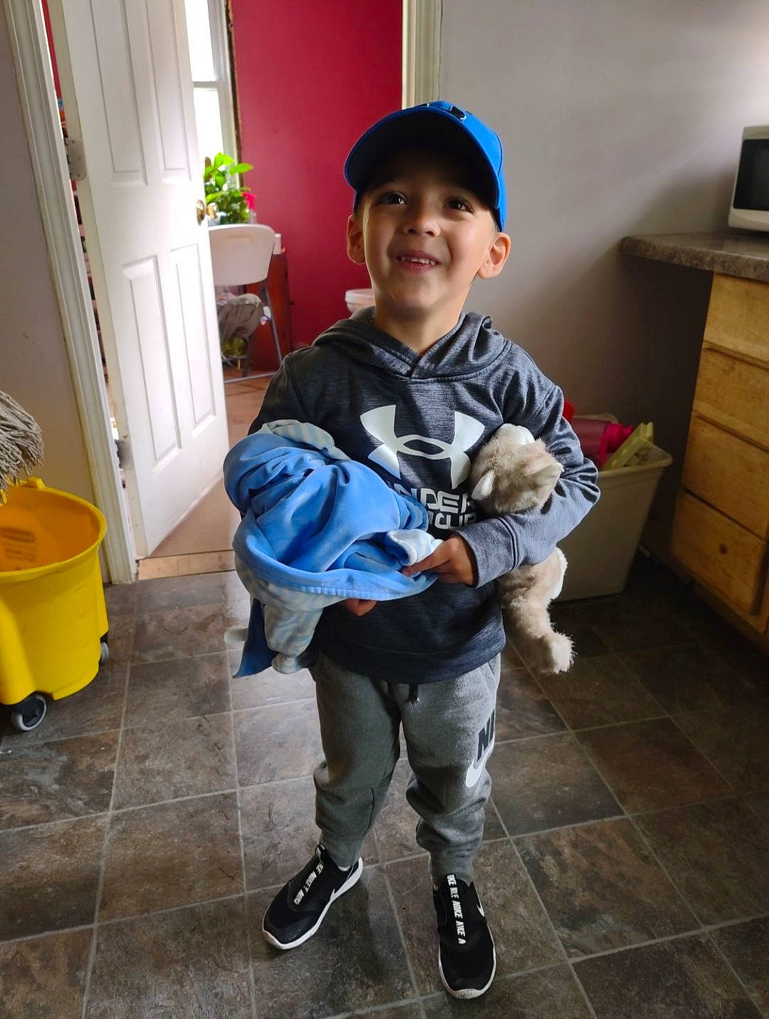 Azazel joined the competition — help win amazing prizes! baseball_cap, cabinetry, cap, companion_dog, door, drawer, flooring, fun, headwear, houseplant, joy, knee, person, shoe, shoulder, sleeve, smile, sneakers, standing, t_shirt