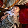 Ryleigh is registered to the contest to win money with this photo: baby, sleeping, blanket, plush_toy, couch, person, red_clothing, under_armour, indoors, cozy, child, soft_toy, hand, comfort, rest, head, face, pajamas, relaxation, nap