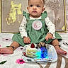 baby, infant, child, girl, green_dress, headband, bow, cake, strawberry, chocolate, plate, blanket, flower_pattern, celebration, birthday, milestone, sitting, cute, indoors, portrait