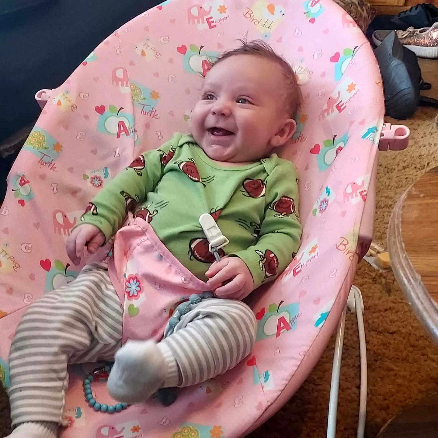 Beau Wesley Graham joined the competition — help win amazing prizes! baby, infant, smiling, baby_chair, pink, green_onesie, striped_leggings, toy, living_room, carpet, furniture, happy, child, cute, indoor, person, seat, footwear, wooden_cabinet, cozy