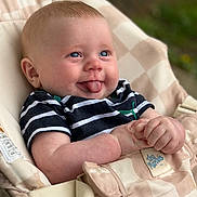 Wyatt joined the competition — help win amazing prizes! baby, child, tongue_out, striped_shirt, blue_eyes, baby_carrier, cheeky, smiling, cute, infant, hands, seat, comfortable, portrait, outdoor, closeup, playful, expression, young, happy