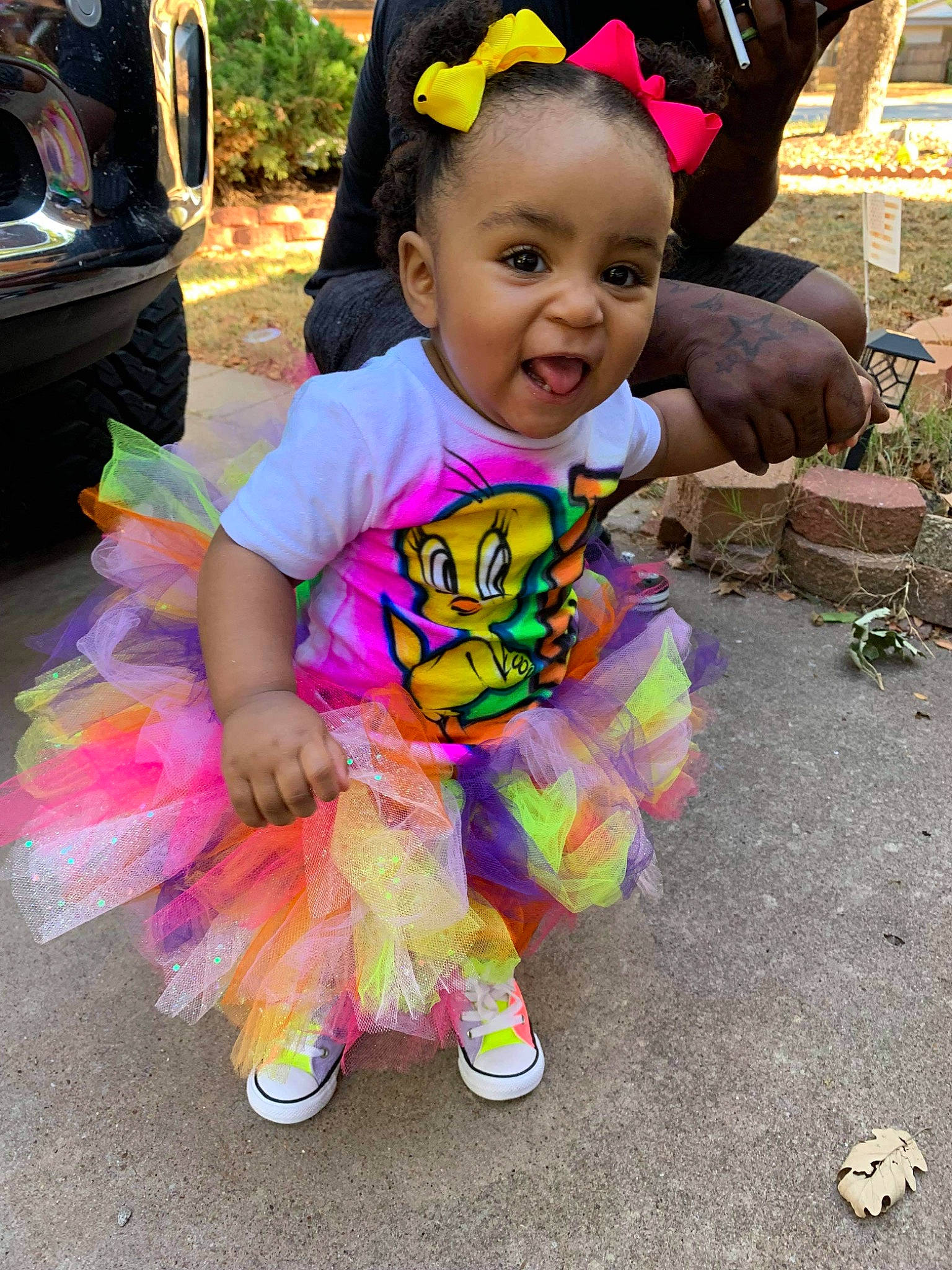 Alex is registered to the contest to win money with this photo: baby, baby_toddler_clothing, child, event, facial_expression, fashion_accessory, fun, grass, hairstyle, happy, leisure, magenta, person, pink, plant, purple, recreation, sitting, smile, toddler