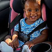 Seven joined the competition — help win amazing prizes! baby, child, car_seat, smiling, happy, blue_clothing, socks, seatbelt, curly_hair, infant, car_interior, sunlight, cute, portrait, safety, seat, vehicle, small_child, person, car
