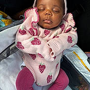 Miracle is registered to the contest to win money with this photo: baby, sleeping, pink_sweater, strawberry_pattern, headband, car_seat, tights, infant, cute, cozy, child, peaceful, portrait, clothing, resting, adorable, closeup, indoor, person, newborn