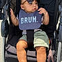 baby, stroller, sunglasses, bib, child, casual_clothing, legs, footwear_free, outdoor, sunlight, accessory, expression, cute, infant, seatbelt, fabric, relaxed, person, summer, shade