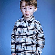 Max is registered to the contest to win money with this photo: child, boy, plaid_shirt, portrait, smile, standing, indoor, blue_background, casual_clothing, young, cute, person, fashion, hair, eyes, face, childhood, happy, model, studio