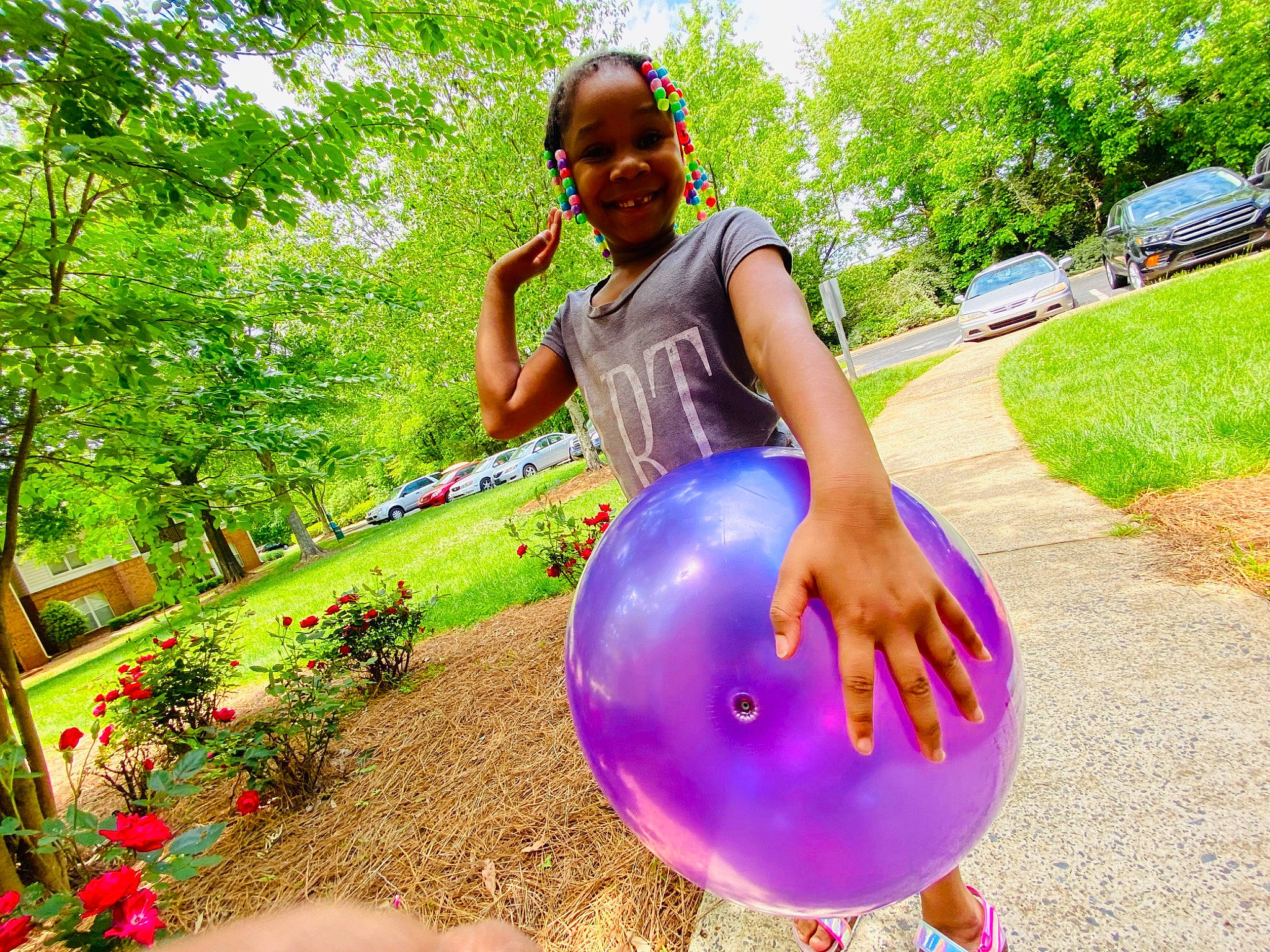 Christian is registered to the contest to win money with this photo: automotive_wheel_system, balloon, dress, electric_blue, flower, fun, garden, grass, green, happy, joy, leisure, magenta, party_supply, people_in_nature, person, plant, recreation, smile, tire