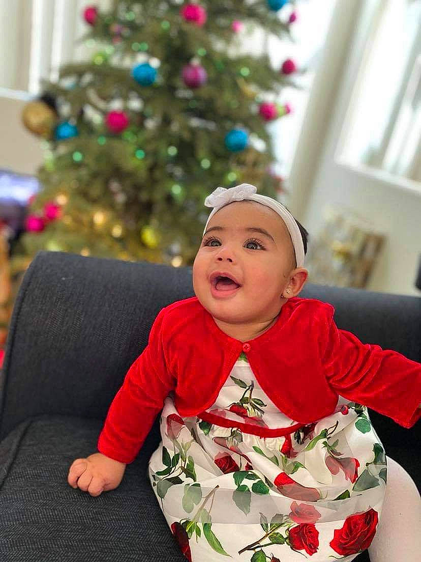 Time joined the competition — help win amazing prizes! baby, baby_toddler_clothing, christmas, christmas_decoration, christmas_eve, christmas_ornament, christmas_tree, comfort, couch, eye, headwear, holiday, interior_design, living_room, mouth, nose, ornament, person, sleeve, toddler