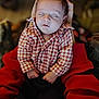 Ossie Schneider is registered to the contest to win money with this photo: baby, sleeping, infant, child, checkered_shirt, red_clothing, hands, portrait, cute, peaceful, cozy, person, indoor, closeup, soft_light, gentle, resting, young_child, holding, casual_clothing