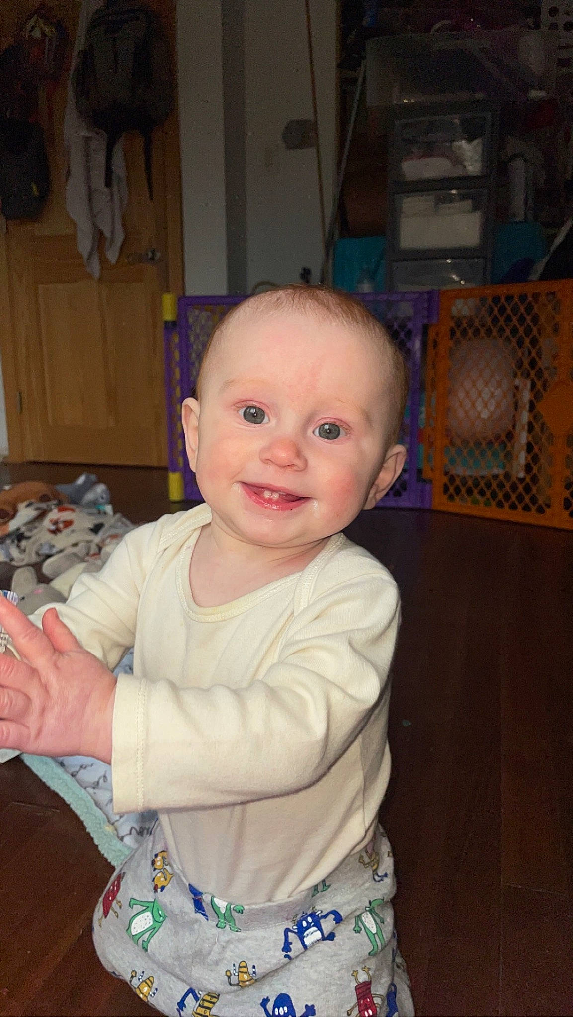 Brysen is registered to the contest to win money with this photo: baby, baby_products, baby_toddler_clothing, bookcase, cheek, child, eye, flooring, fun, happy, hardwood, iris, joy, nose, person, room, sitting, skin, sleeve, smile