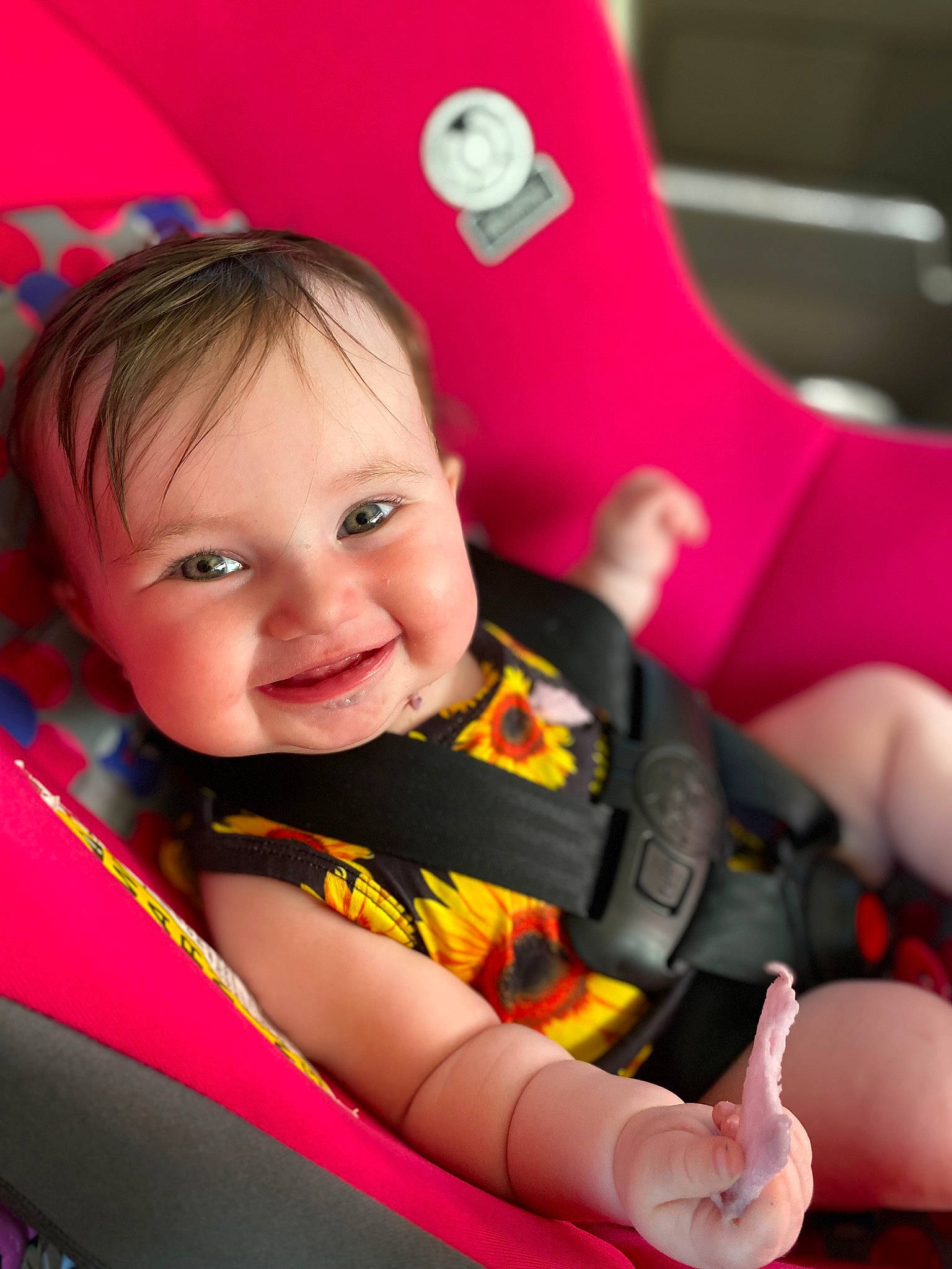 Stella is registered to the contest to win money with this photo: baby, baby_carriage, baby_toddler_clothing, cheek, comfort, eye, face, facial_expression, finger, fun, hairstyle, happy, head, iris, joy, leisure, person, pink, seat_belt, skin