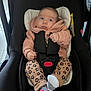 baby, car_seat, infant, clothing, hoodie, leopard_print, socks, safety_harness, indoor, tile_floor, black, pink, cute, child, young, seated, portrait, expression, person, face