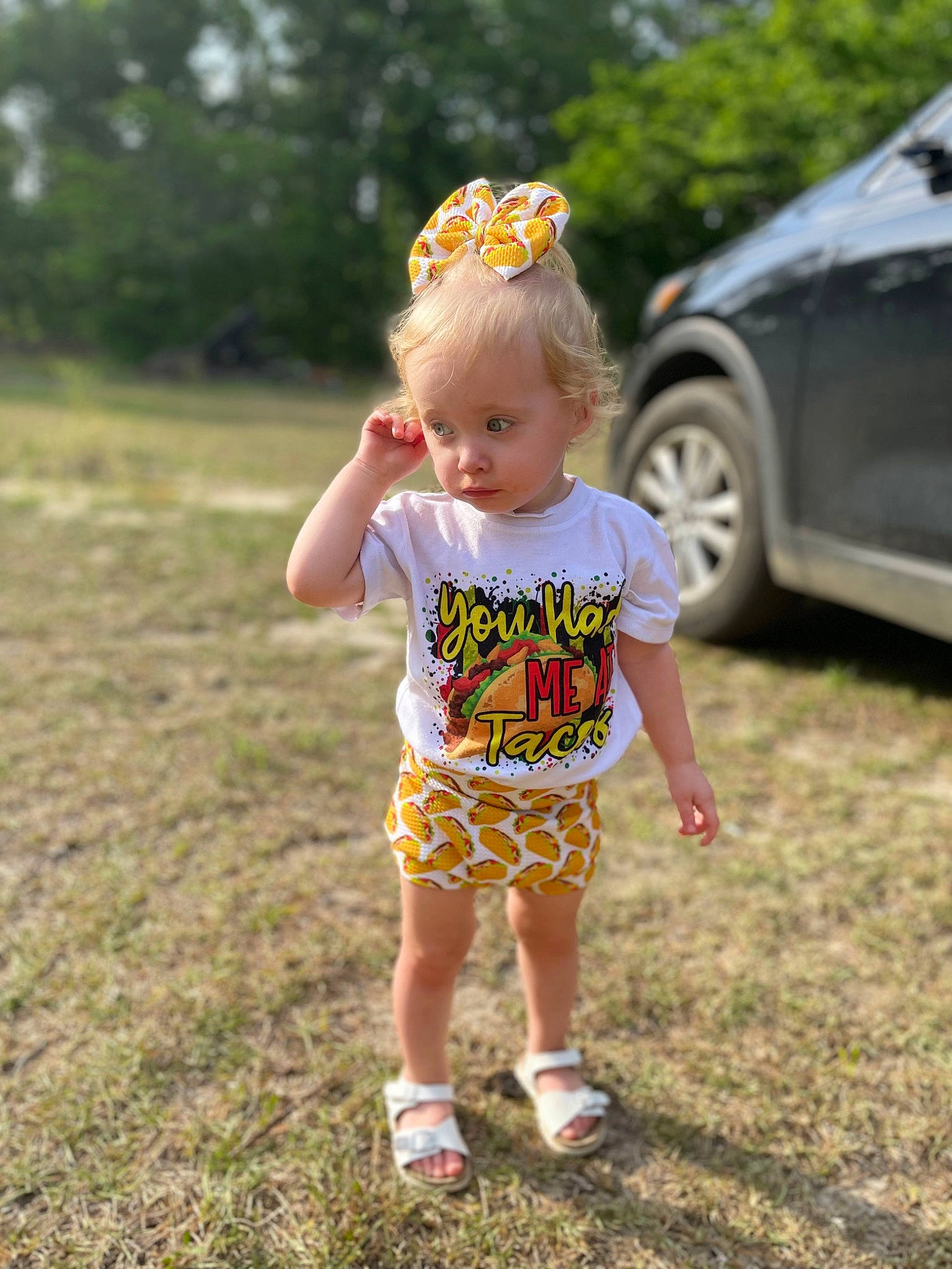 Madilynn is registered to the contest to win money with this photo: baby, baby_toddler_clothing, car, child, fun, grass, grassland, happy, lawn, leisure, people_in_nature, person, plant, recreation, summer, t_shirt, tire, toddler, tree, vehicle_door
