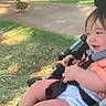 Jack joined the competition — help win amazing prizes! toddler, child, stroller, orange_shirt, outdoor, grass, sidewalk, duck, happy, smiling, baby, seatbelt, sunlight, nature, cute, person, young_child, park, daylight, playful