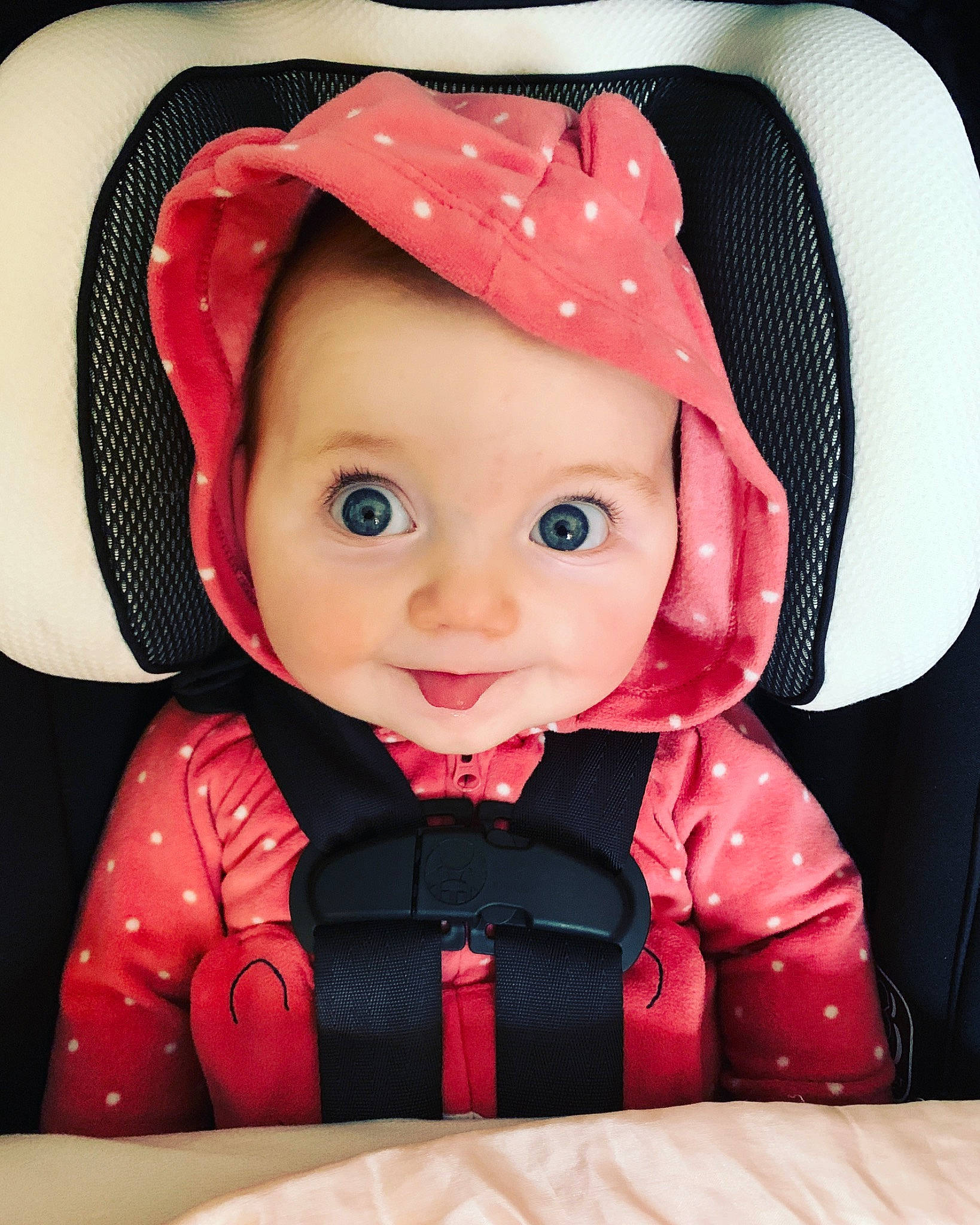 Aislyn is registered to the contest to win money with this photo: baby, cap, cheek, chin, costume_hat, eye, happy, hat, head, headgear, helmet, jacket, outerwear, person, personal_protective_equipment, pink, sleeve, smile, sun_hat, toy
