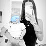 baby, woman, selfie, mirror, tattoo, phone, indoor, window, black_and_white, clothing, person, bedroom, arm, holding, pants, shirt, reflection, casual, portrait, home