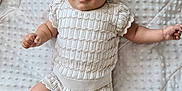 Nuria is registered to the contest to win money with this photo: baby, infant, smile, headband, knitwear, blanket, texture, soft, cute, lying_down, happy, child, skin, arm, leg, indoors, comfort, portrait, person, newborn