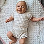 baby, infant, smile, headband, knitwear, blanket, texture, soft, cute, lying_down, happy, child, skin, arm, leg, indoors, comfort, portrait, person, newborn