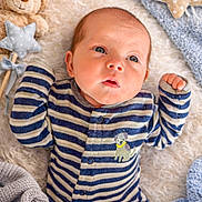 Weston is registered to the contest to win money with this photo: baby, infant, onesie, striped_clothing, plush_toy, blanket, soft_texture, blue, beige, curious_expression, lying_down, cute, child, sleepwear, home, cozy, face, person, newborn, comfort