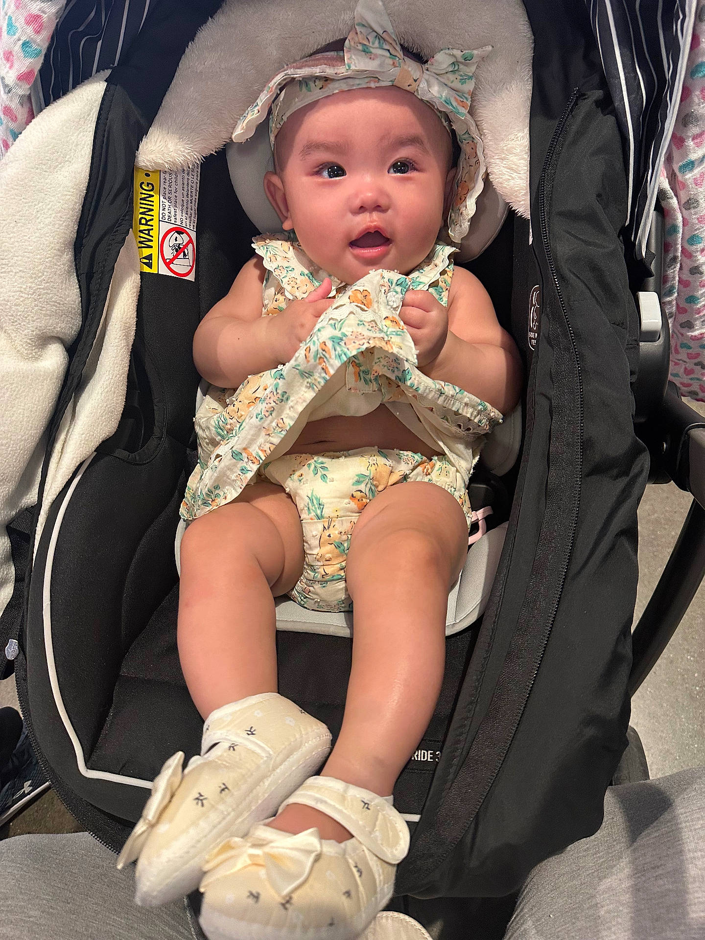 Raelyn joined the competition — help win amazing prizes! apparel, baby, baby_girl, car_seat, child, closeup, clothing, comfort, cute, fabric, happy, headband, indoor, infant, pattern, person, seat, shoes, sitting, small_shoes