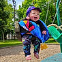 Cole is registered to the contest to win money with this photo: baby, infant, swing, playground, park, blanket, colorful_hat, drooling, smiling, chains, toy_car, bare_feet, leggings, wood_chips, trees, greenery, outdoor, sunny_day, child, happy