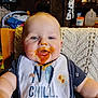 Cole joined the competition — help win amazing prizes! baby, infant, bib, orange_food, messy_face, feeding, highchair, blue_eyes, tongue, drool, close_up, smile, cheeks, clothing, blanket, chair, kitchen, food_spill, jar, portrait