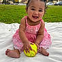 Delilah joined the competition — help win amazing prizes! baby, blanket, child, curly_hair, cute, daylight, feet, fun, grass, happy, nature, outdoor, park, person, pink_dress, playful, sitting, smiling, softball, summer