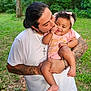 Olivia joined the competition — help win amazing prizes! baby, child, man, father, outdoor, greenery, tattoo, kiss, love, family, smile, headband, pink_clothing, grass, tree, nature, holding, affection, happy, portrait
