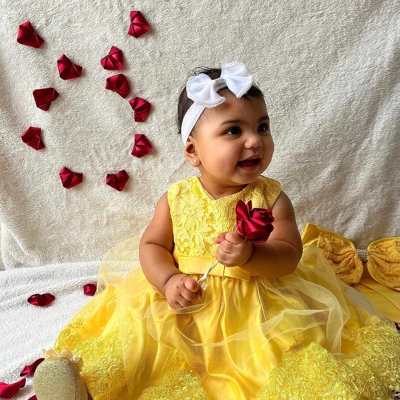 Brillith joined the competition — help win amazing prizes! baby, blanket, celebration, child, cute, decor, fabric_flowers, golden_shoes, happy, headband, heart_shape, indoors, portrait, red_rose, rose_petals, sitting, smiling, white_bow, yellow_dress, young_child