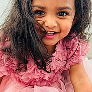 Aira joined the competition — help win amazing prizes! child, girl, toddler, portrait, smiling, happy, indoors, pink_dress, frilly_dress, hair_bow, long_hair, brown_hair, brown_eyes, teeth, close_up, sitting, fashion, home, framed_picture, photography