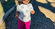 Aira joined the competition — help win amazing prizes! child, toddler, girl, sunglasses, outdoor, portrait, standing, smiling, fashion, headband, floral_shirt, pink_pants, sneakers, playground, path, gravel, park, sunlight, shadows, trees