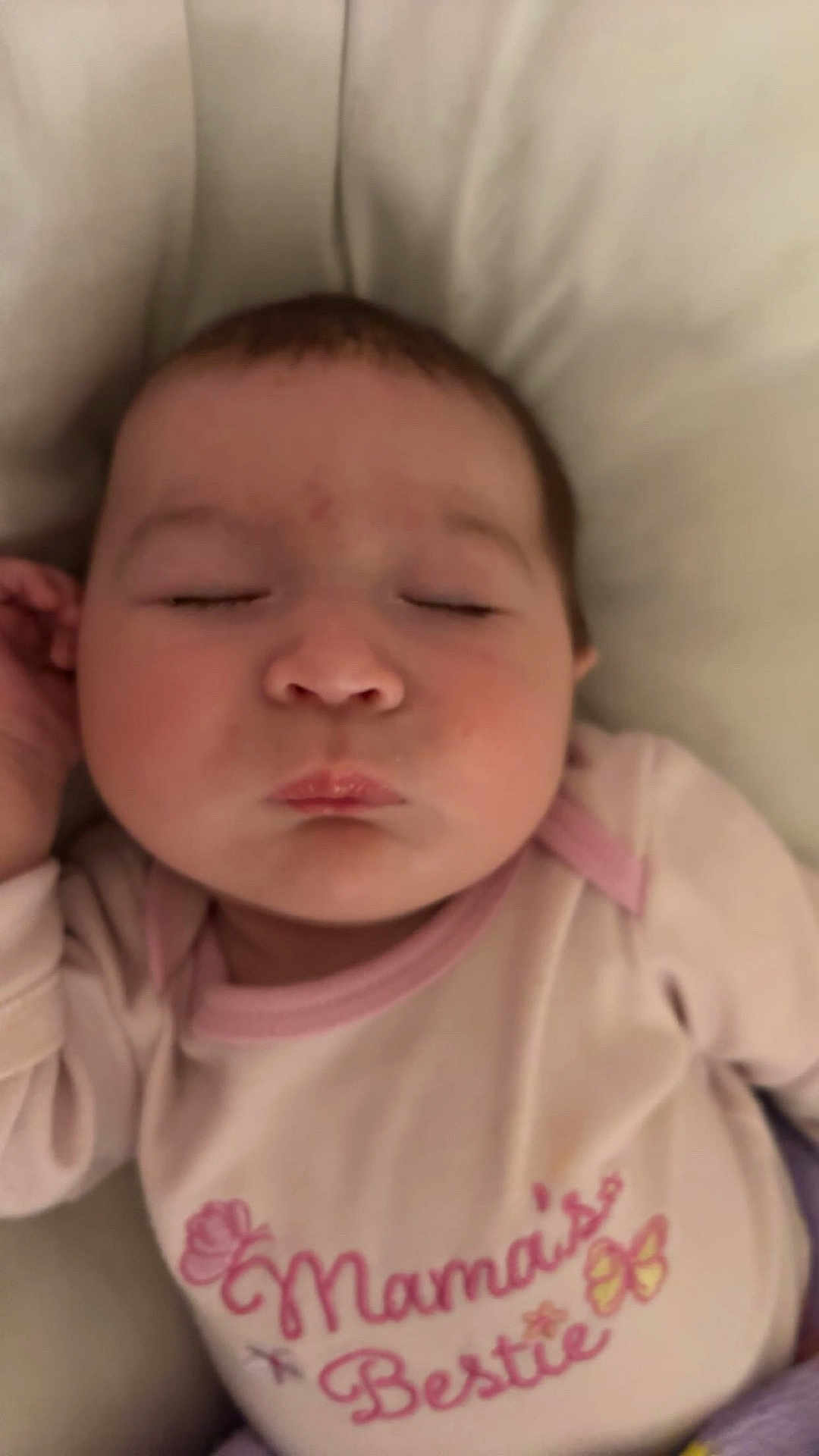 Isabelle is registered to the contest to win money with this photo: baby, infant, sleeping, closed_eyes, face, onesie, pink, pillow, bed, mouth, cheeks, newborn, cozy, indoor, portrait, peaceful, lips, hand, clothing, head