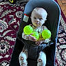 Tyson joined the competition — help win amazing prizes! baby, child, infant, sitting, bouncer, baby_seat, green_balls, toy, tractor, rug, indoor, floor, portrait, wide_eyed, blonde_hair, onesie, bare_feet, playroom, furniture, colorful